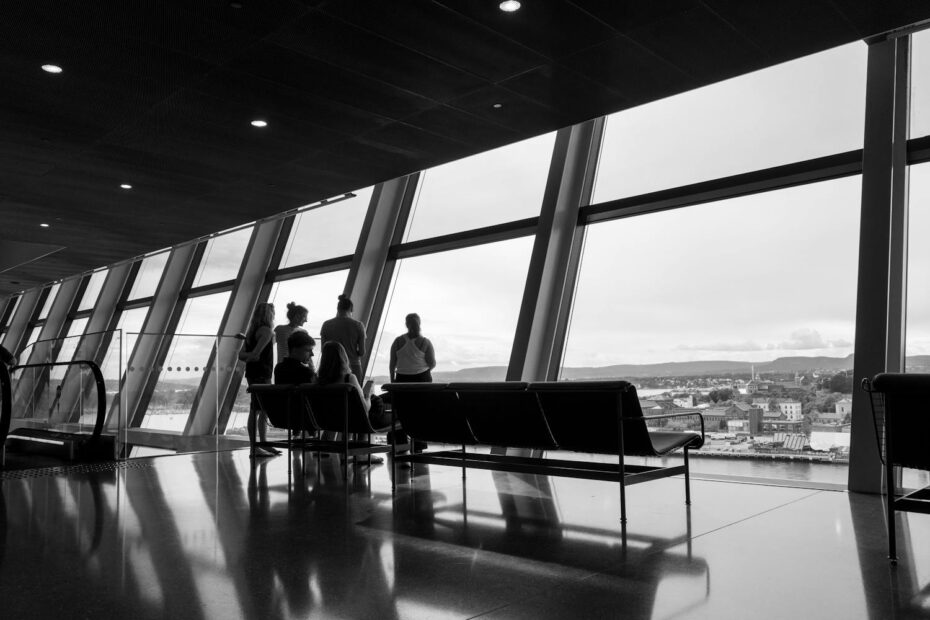 Black and white photo of people waiting for their flight
