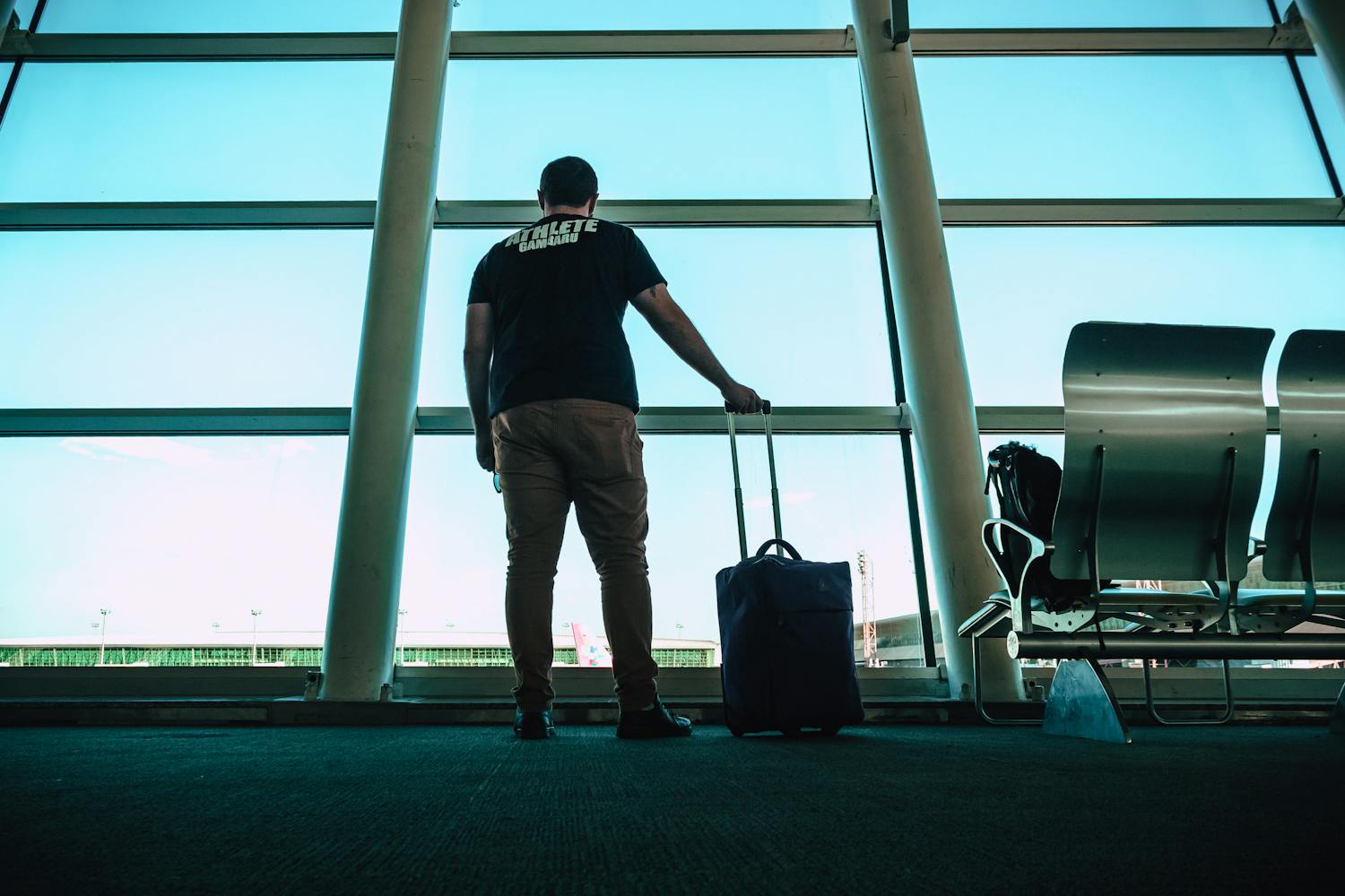 Man with a suitcase waiting for his flight